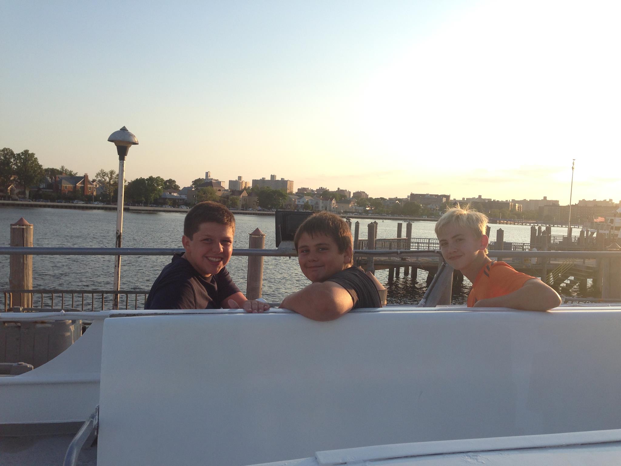 Noah Travis and Brendan sitting on the boat waiting to head out to fish.